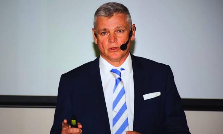 Arnaud Lagesse presenting to an audience with a headset microphone